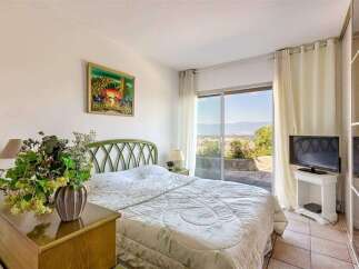 Wake up to breathtaking views from this bedroom with a sliding glass door leading to a private patio.