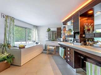Luxurious bathroom with a large built-in bathtub and double vanity.