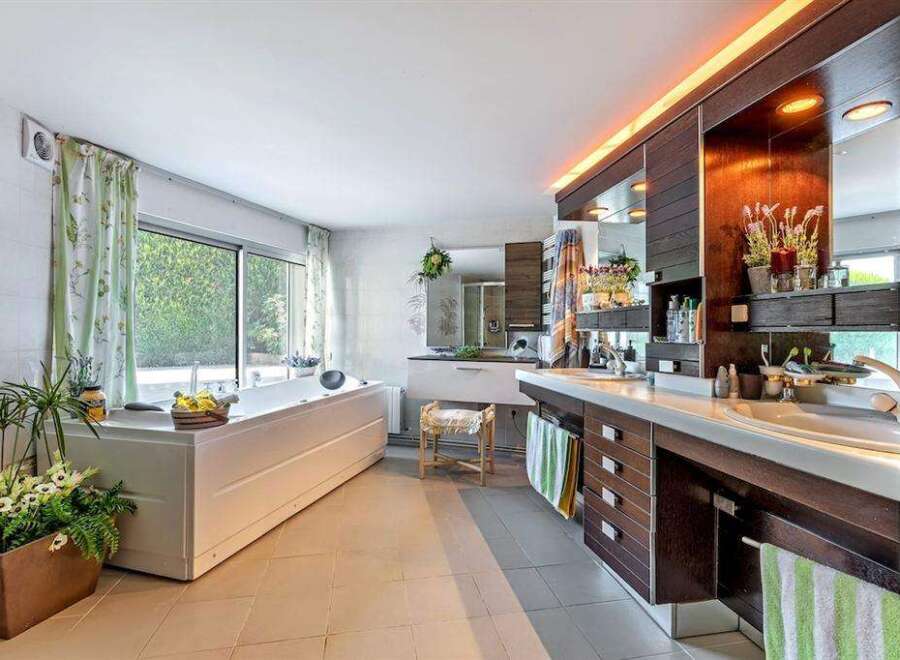 Luxurious bathroom with a large built-in bathtub and double vanity.