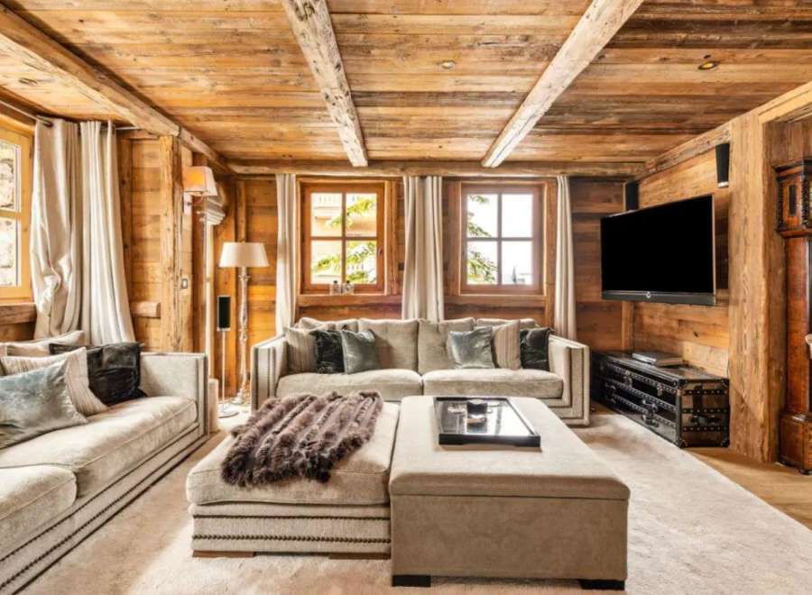 This stunning chalet boasts a spacious living area with a cozy, rustic feel.