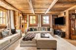 This stunning chalet boasts a spacious living area with a cozy, rustic feel.