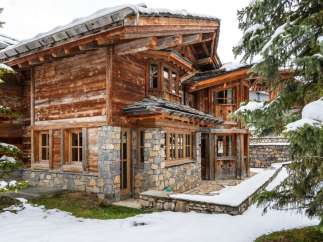 This stunning chalet boasts a unique blend of rustic charm and modern elegance.