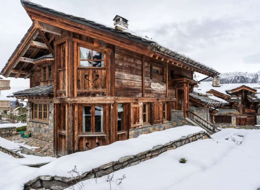 This stunning chalet boasts a unique blend of rustic charm and modern comfort, nestled in a breathtaking snowy mountain setting.
