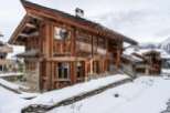 This stunning chalet boasts a unique blend of rustic charm and modern comfort, nestled in a breathtaking snowy mountain setting.