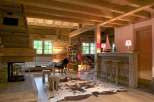 Rustic mountain chalet with exposed wood beams, a cozy fireplace, and a stylish bar area.