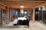This stunning chalet boasts a spacious open-plan living area with a large dining table perfect for entertaining.