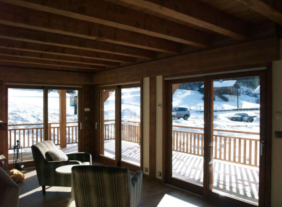 Luxurious chalet with stunning mountain views and floor-to-ceiling windows.