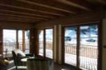 Luxurious chalet with stunning mountain views and floor-to-ceiling windows.