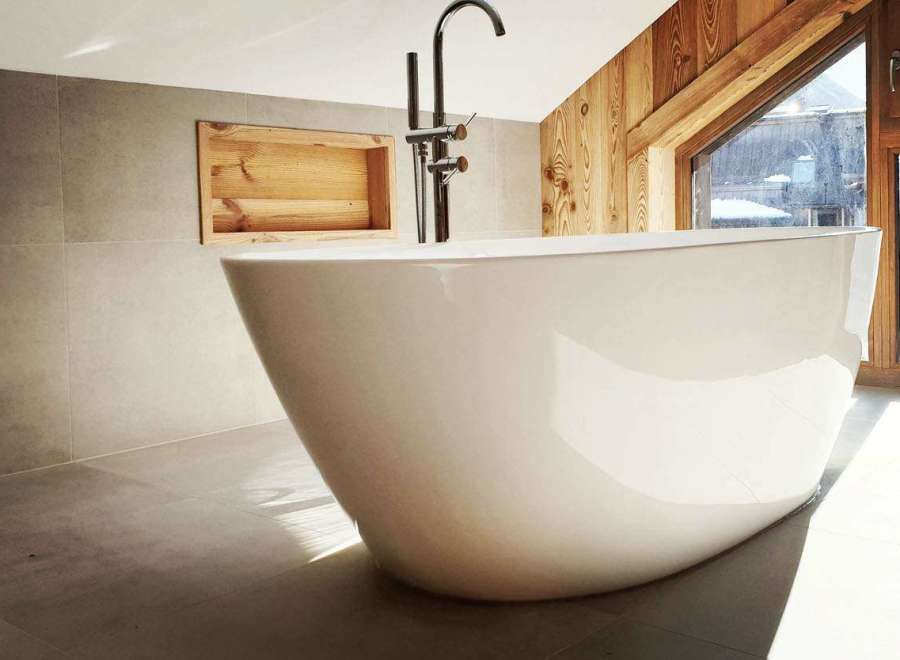 Indulge in luxury with this stunning bathroom featuring a modern freestanding tub.
