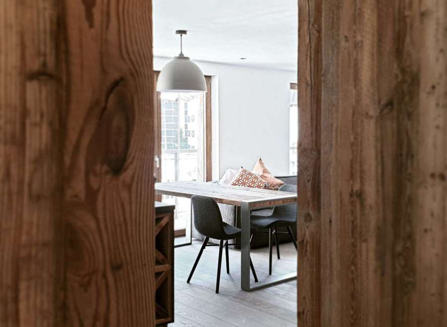 Discover the charm of this inviting dining space, framed by rustic wooden accents.