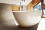 Indulge in luxury with this stunning bathroom featuring a modern freestanding tub.