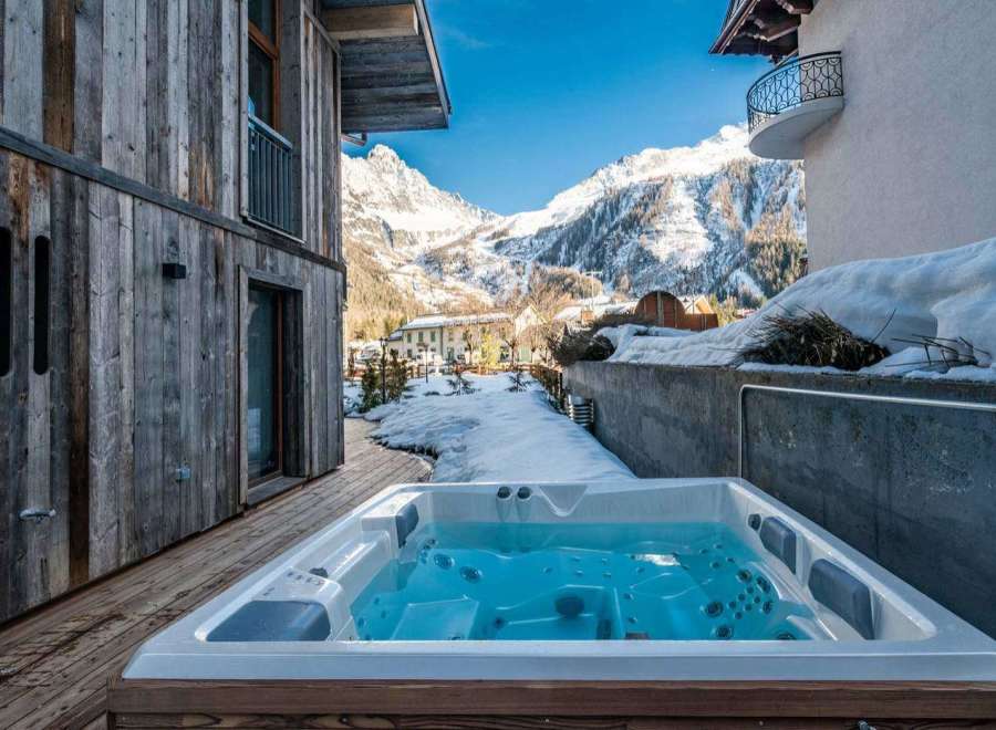 Escape to a luxurious mountain retreat with a private hot tub overlooking stunning alpine views.