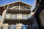 This stunning wooden chalet boasts multiple balconies, offering breathtaking views of the surrounding landscape.