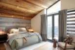 Luxury chalet bedroom with stunning mountain views.