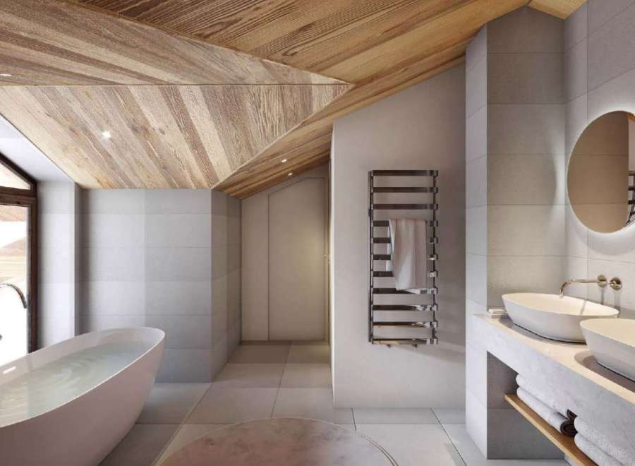 Luxurious bathroom boasts a freestanding tub, heated towel rack, and sleek double sinks.