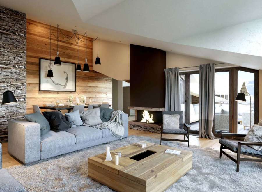 This stunning chalet boasts a spacious open-plan living area with a cozy fireplace, perfect for relaxing after a day on the slopes.