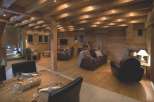 Luxurious chalet with exposed wooden beams, a cozy fireplace, and ample seating for relaxation.