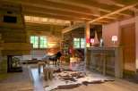 Rustic mountain chalet with exposed wood beams, a cozy fireplace, and a stylish bar area.