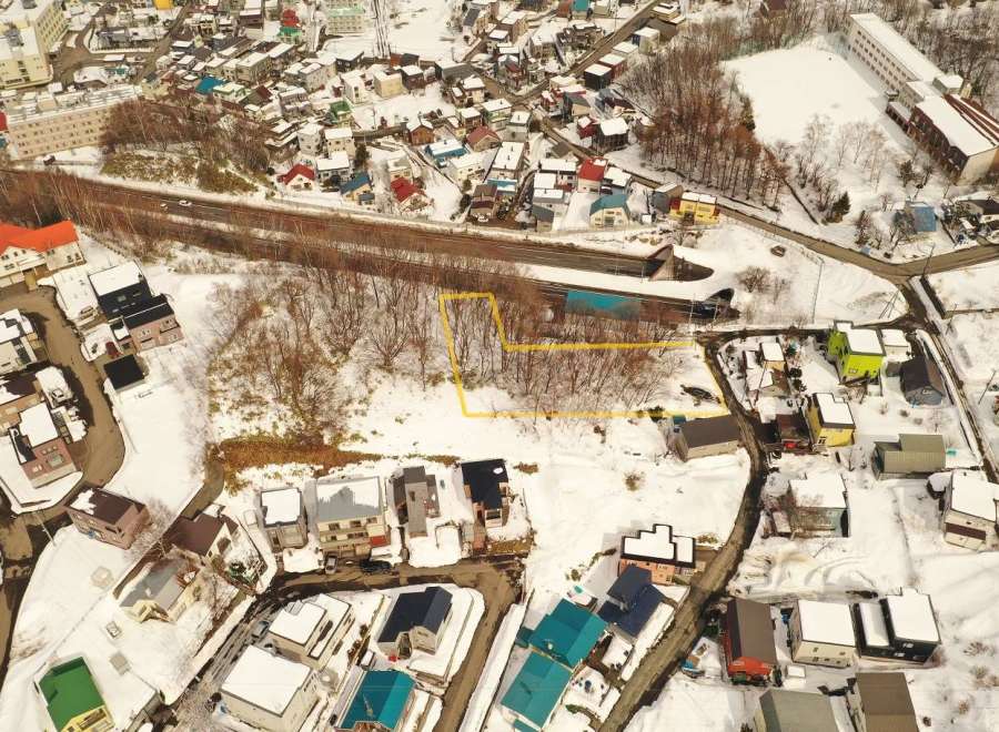 Discover a prime real estate opportunity in a picturesque, snow-covered town.