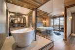 Experience luxury in this stunning property featuring a modern bathroom with a sleek, freestanding tub.