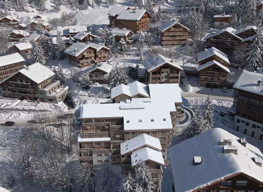Experience the charm of a snow-covered village with stunning chalets.