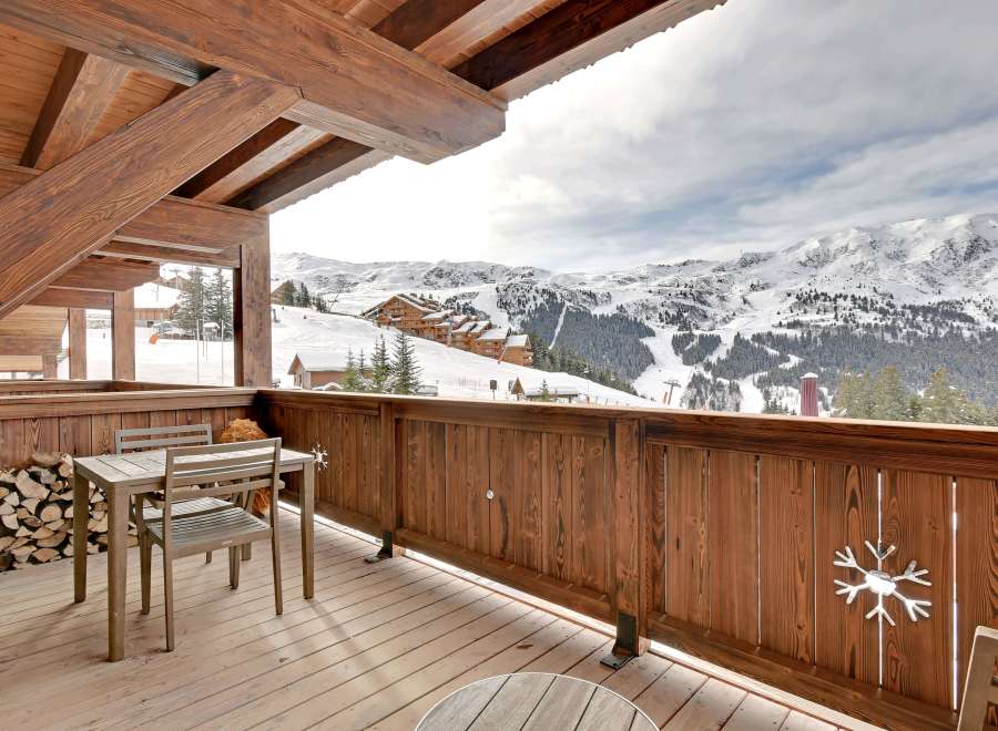 Enjoy breathtaking mountain views from this stunning chalet balcony.