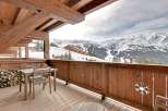 Enjoy breathtaking mountain views from this stunning chalet balcony.