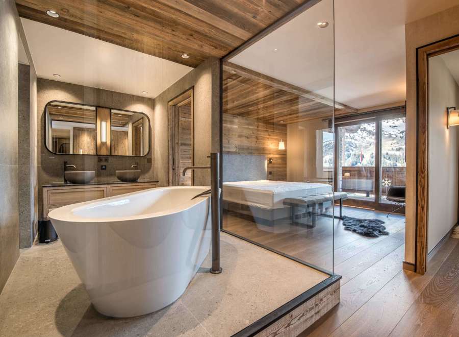 Experience luxury in this stunning property featuring a modern bathroom with a sleek, freestanding tub.