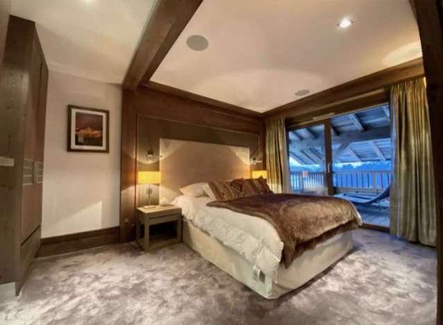 Luxurious chalet bedroom with stunning mountain views.
