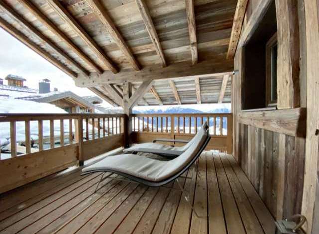 Relax on your private balcony with mountain views and enjoy the rustic charm of this chalet.