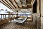 Relax on your private balcony with mountain views and enjoy the rustic charm of this chalet.