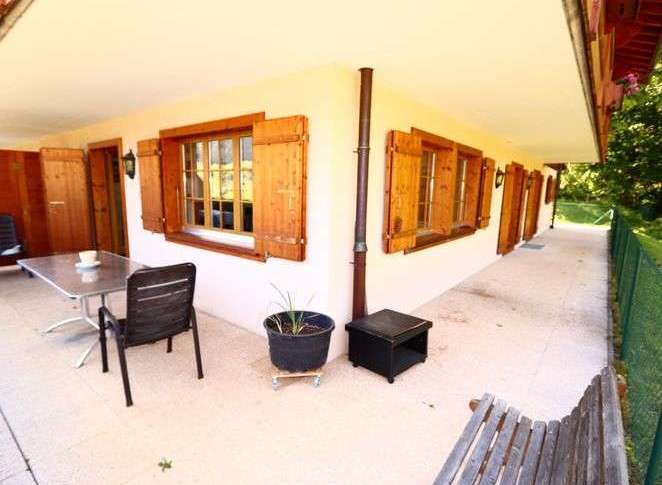 Charming chalet with traditional wooden shutters and windows.