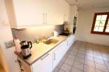 This bright and airy kitchen features modern white cabinetry and sleek countertops, perfect for preparing meals.