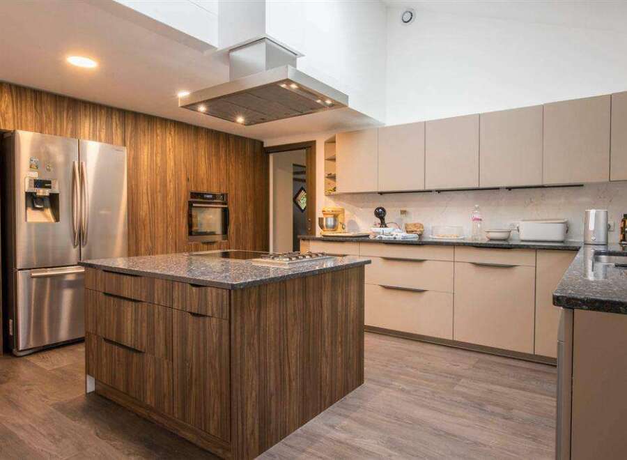 This stunning kitchen boasts modern cabinetry, sleek countertops, and high-end appliances.