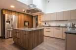 This stunning kitchen boasts modern cabinetry, sleek countertops, and high-end appliances.