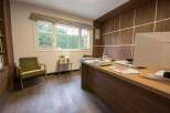 Modern office space with wood paneling and large window.