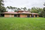 Stunning contemporary home nestled in a tranquil wooded setting.
