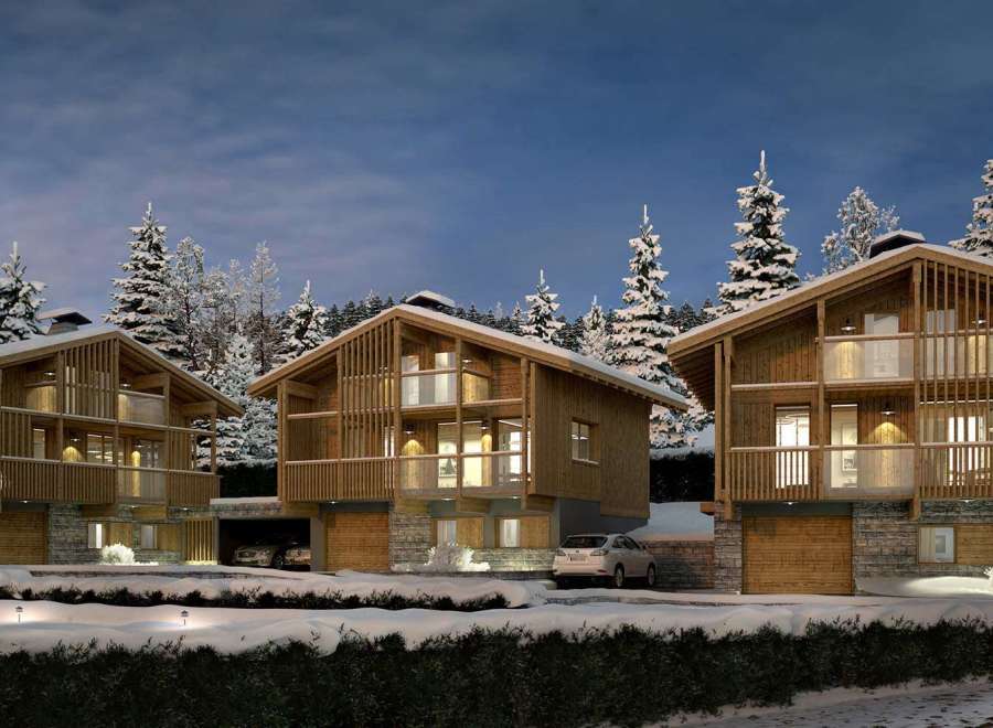 Experience the ultimate winter getaway in these stunning wooden chalets nestled in a snowy landscape.