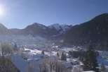 Experience the serene beauty of a snow-covered mountain village.