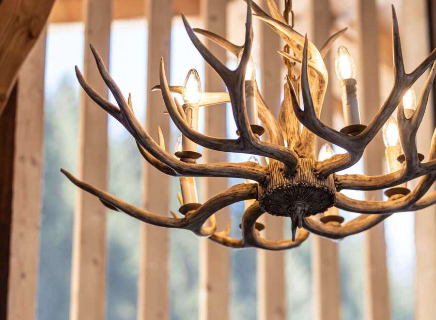 Experience rustic elegance with this stunning antler chandelier, a perfect centerpiece for any lodge or cabin.