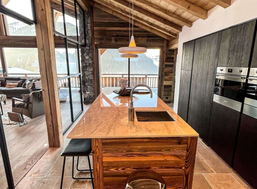 Experience luxury living in this stunning property, showcasing a beautifully designed kitchen with a unique wooden island.