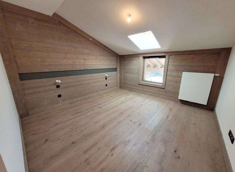 Discover the charm of this unique attic space, featuring stunning wood paneling that adds warmth and character.