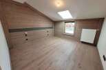 Discover the charm of this unique attic space, featuring stunning wood paneling that adds warmth and character.