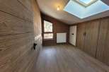 This stunning room features beautiful wooden paneling and flooring, creating a warm and inviting atmosphere.