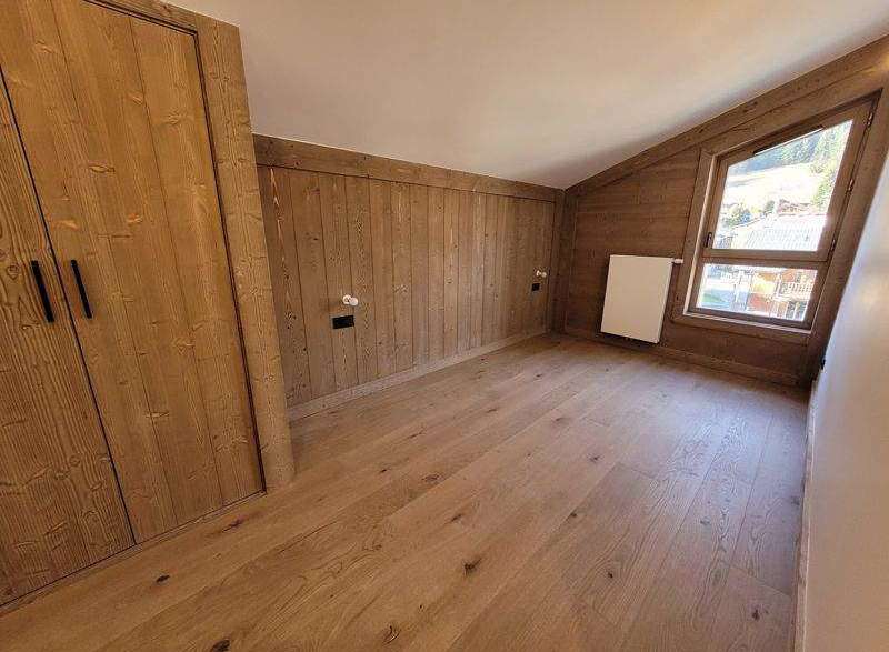 Discover the charm of this cozy room, featuring beautiful wooden paneling and flooring that exudes warmth.
