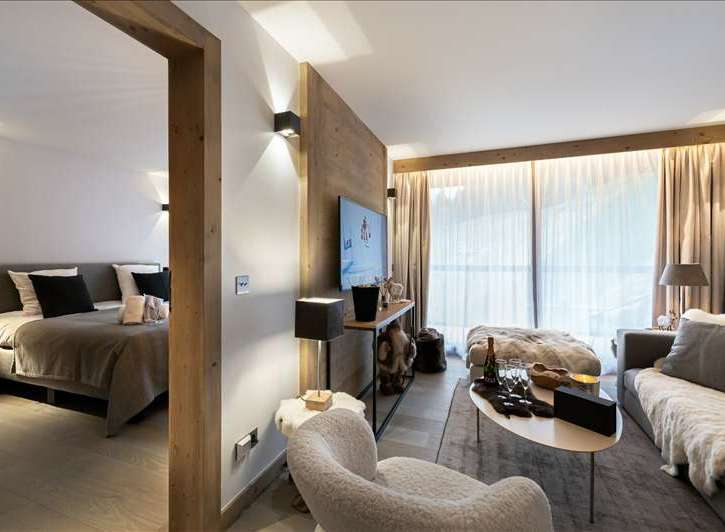 Experience luxury living in this stunning property, featuring a beautifully designed bedroom and a cozy living area.
