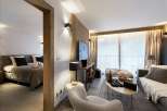 Experience luxury living in this stunning property, featuring a beautifully designed bedroom and a cozy living area.