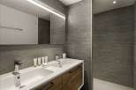 This modern bathroom features a sleek design with a double sink vanity and a large mirror.