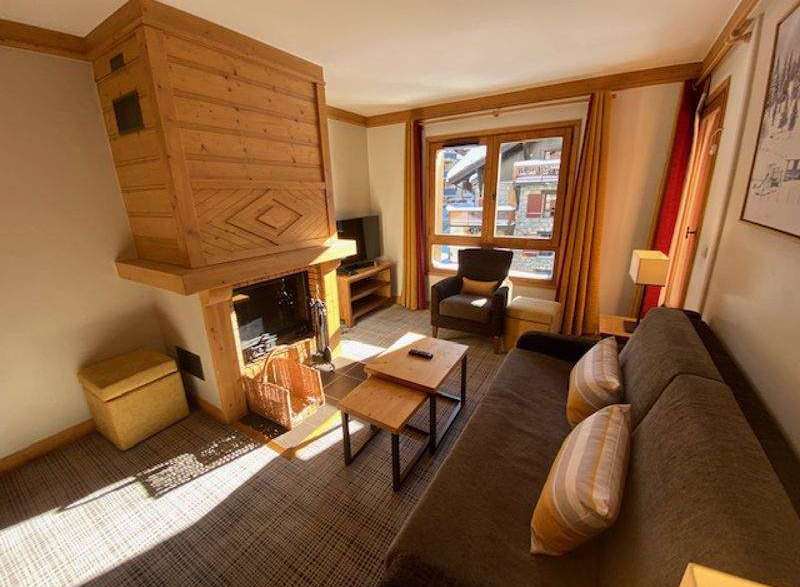 Cozy up in this charming living space, complete with a rustic wooden fireplace.