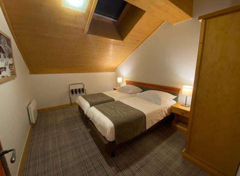 Discover a cozy bedroom with a unique sloped ceiling and a skylight that fills the space with natural light.